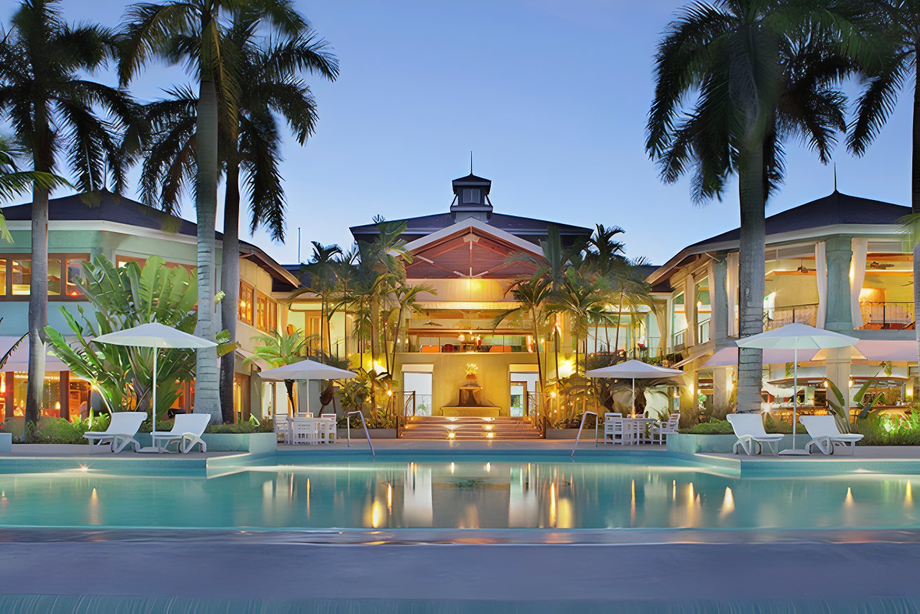 Front view of Couples Negril at night with its lights on