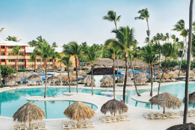 All inclusive resort Iberostar Punta Cana on a sunny day with the pool and palm trees featured