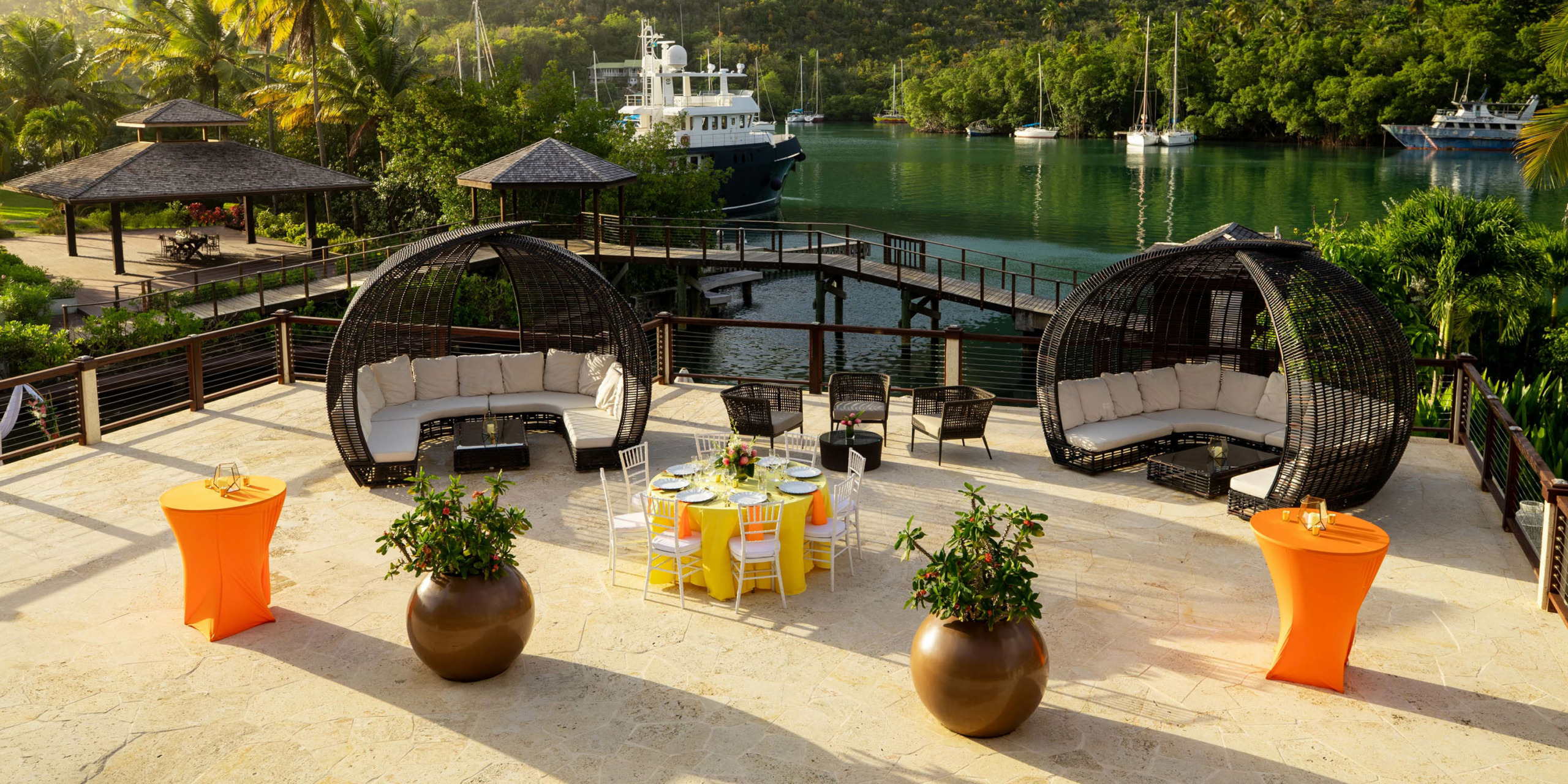 An outdoor dining area with Zoetry Marigot Bay St. Lucia tables and chairs.