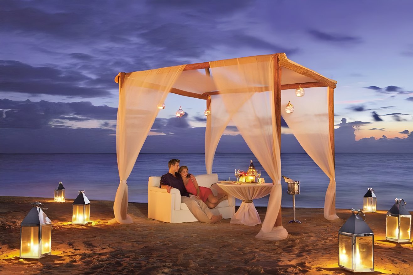 Nighttime fire on a beach at Secrets Royal Beach after a destination wedding with a wedding package under $10,000.