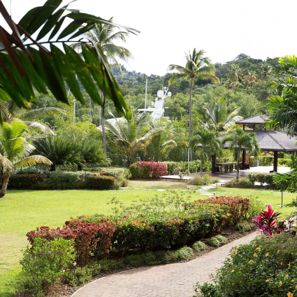 Curved stone pathway in a landscaped garden with tropical plants, perfect for a destination wedding gazebo.