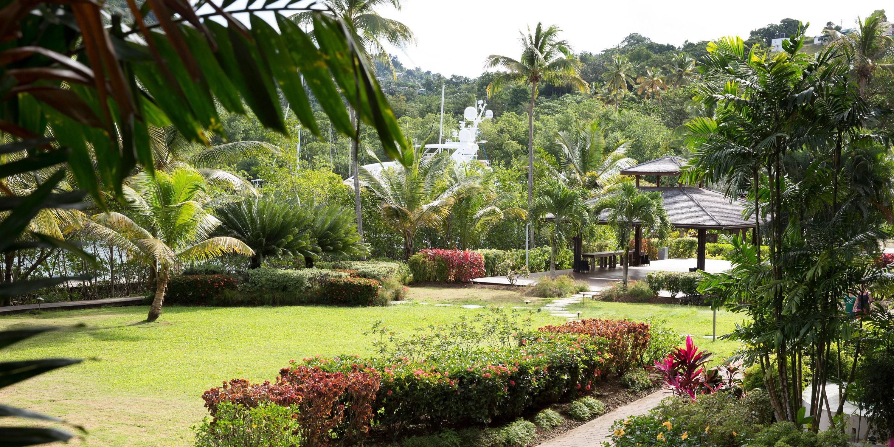 Zoetry Marigot Bay St. Lucia offers a tropical garden with palm trees and gazebo, ideal for weddings.