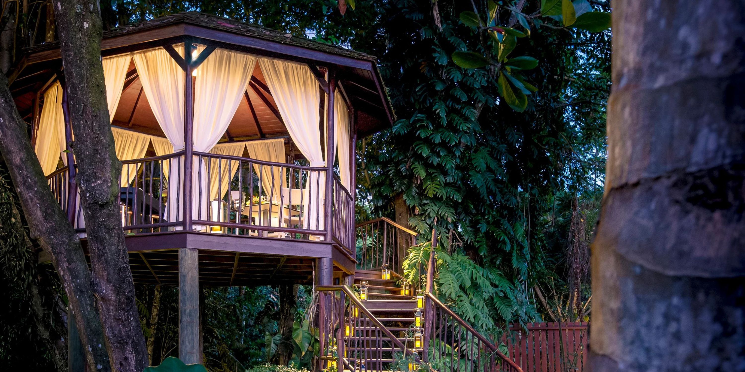 Zoetry Marigot Bay St. Lucia: dreamy treehouse with white curtains, lush greenery, and wedding lights.