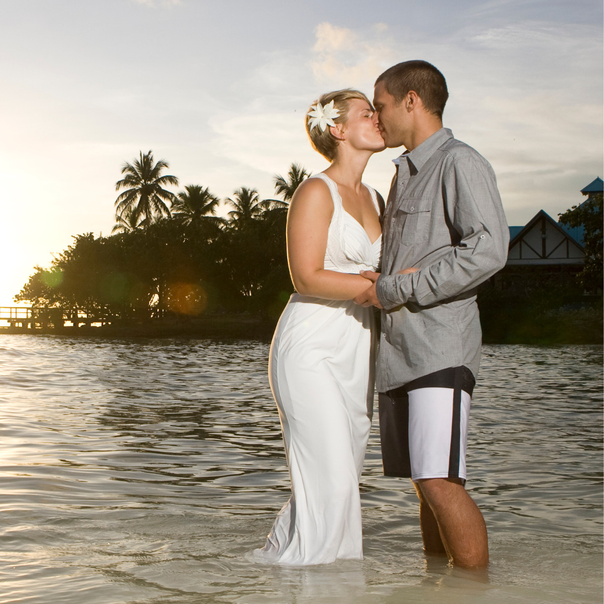 Beautiful couple kissing while standing in the beach water