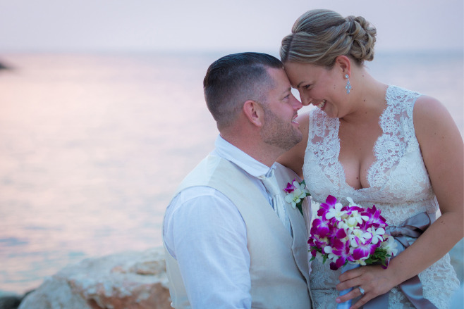 A couple embraces near the beach after their wedding with an all inclusive Jamaica wedding package