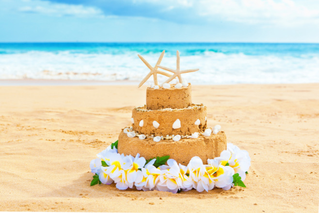 A sandcastle destination wedding cake with starfish