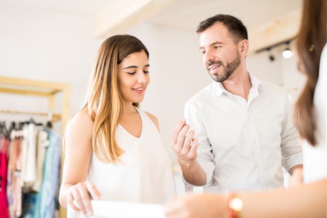 A couple buying a lab grown diamond ring at a shop