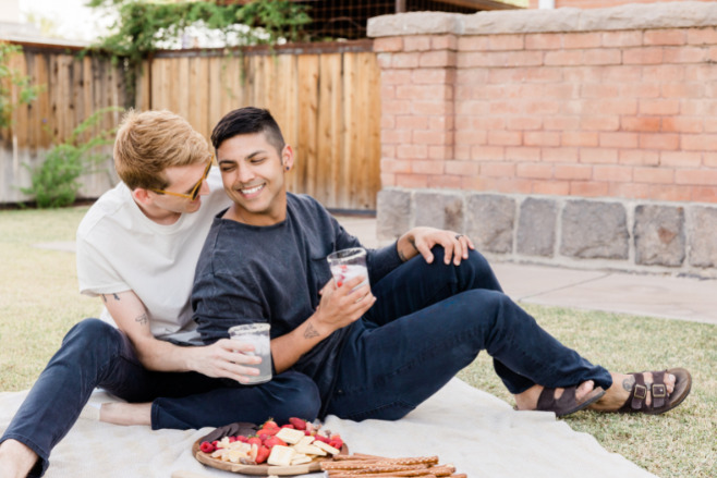 A couple embrace while having a picnic