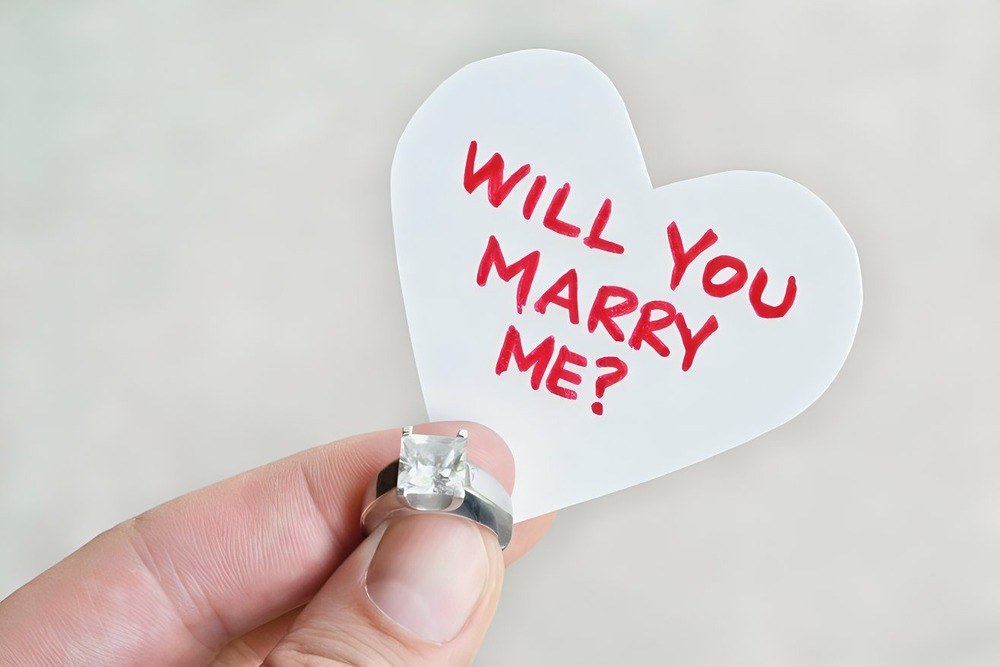 A little heart cutout that says 'Will You Marry Me'