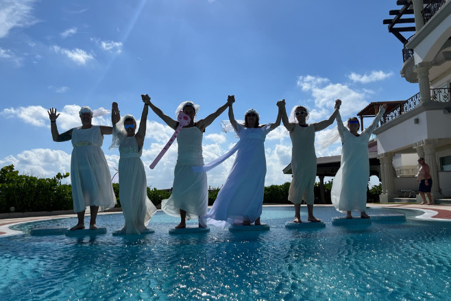 Destify managers in wedding gowns at an annual retreat