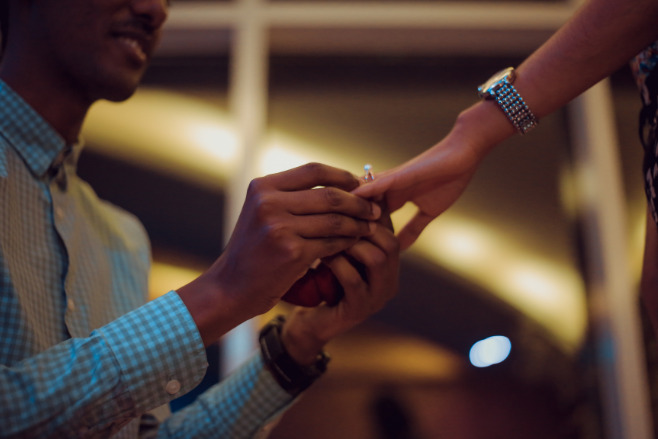 A man proposes to his girlfriend during a sports game