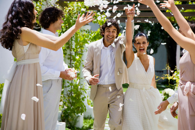 Destination wedding guests shower the couple in cheers after their ceremony.