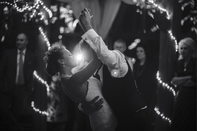 Black and white photograph of a couple after their first dance song