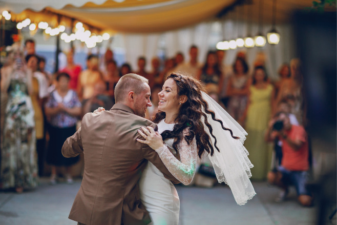 Couple busting a move on the dance floor during their first dance songs