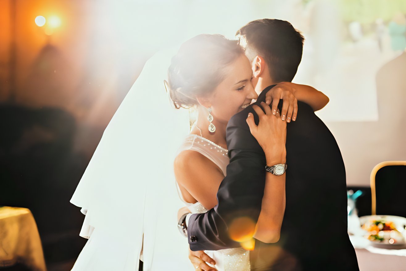 Couple embracing on the dance floor during their first dance song