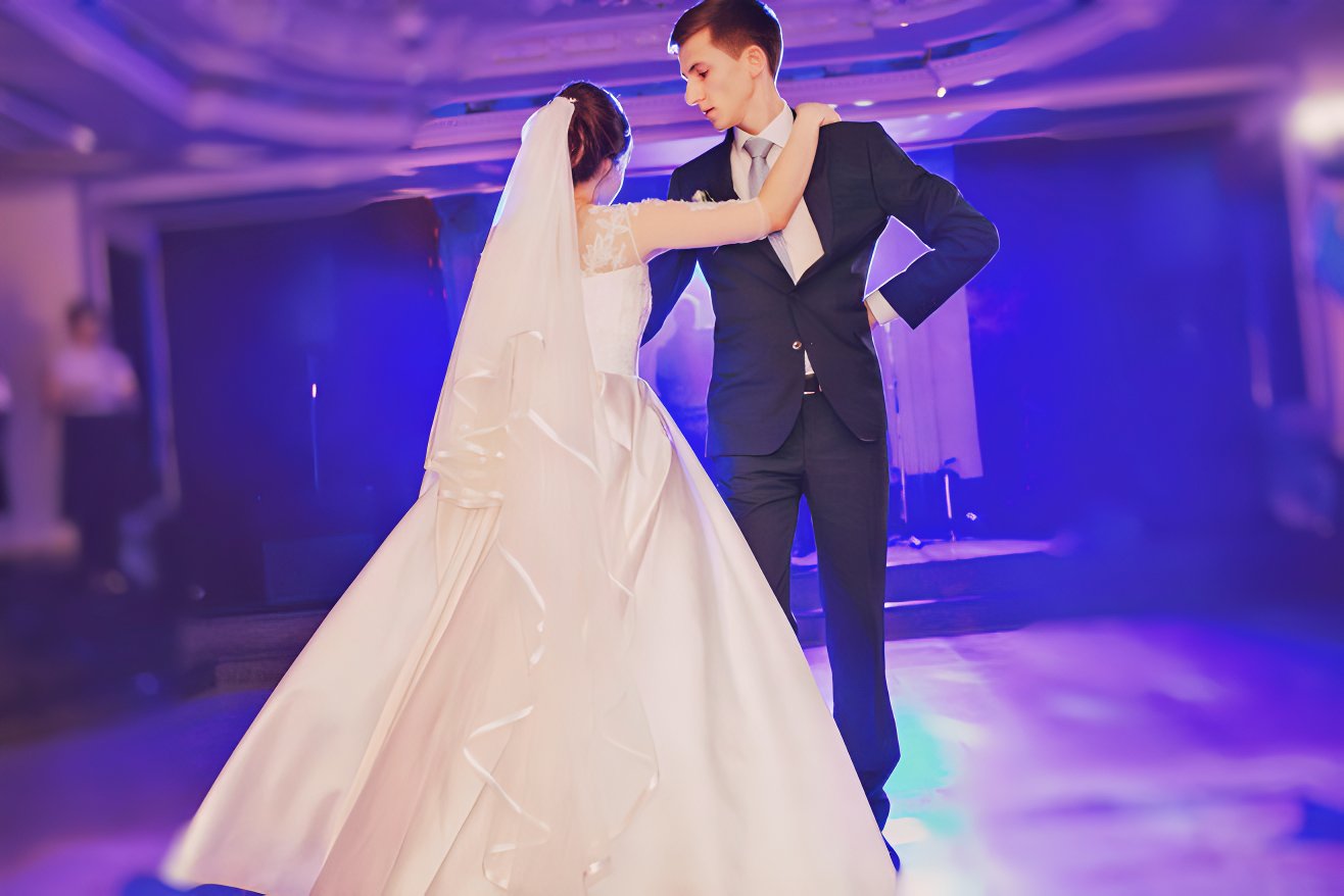 A first dance in a purple-lit room