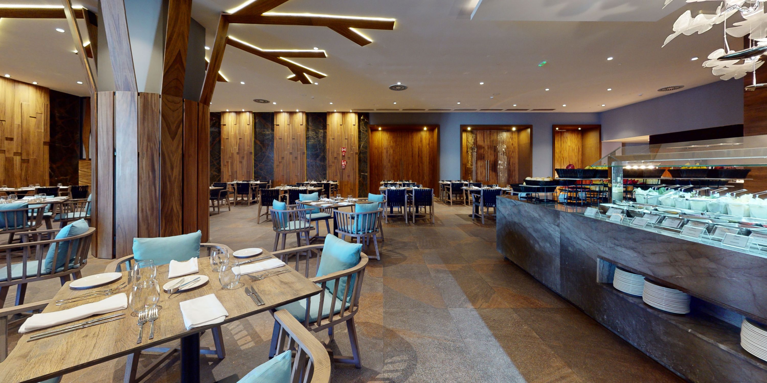 Elegant wedding-ready interior at Royalton Splash Riviera Cancun, wood accents, set tables, buffet counter.