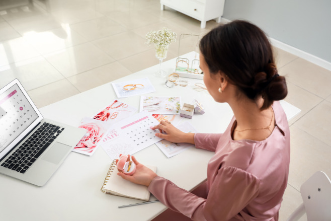 A destination wedding planner sitting behind her desk