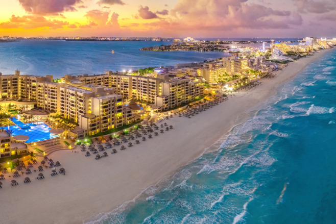 Cancun at sunset, with the orange sky in the distance