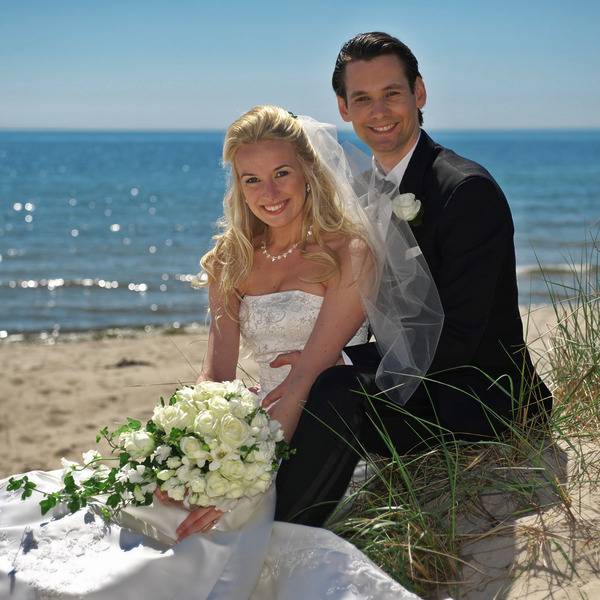 A happy couple on the beach after their destination wedding