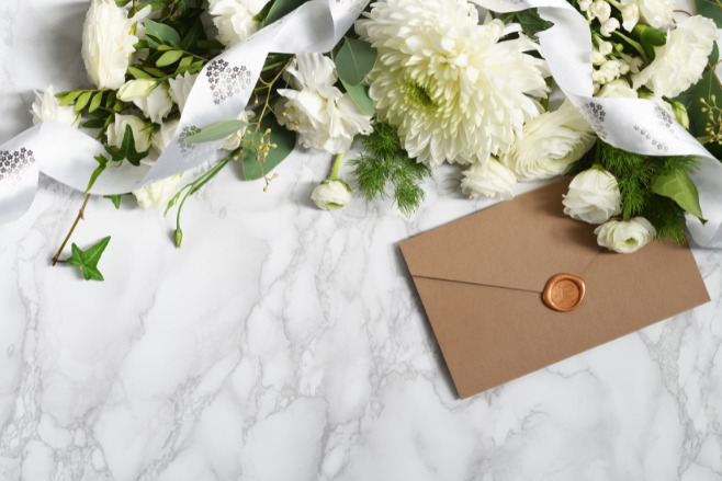 An envelope on a marble table is a creative Destination Wedding Invitations