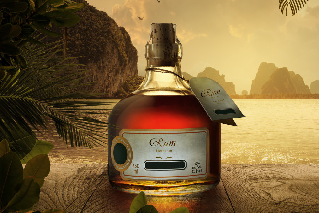 A miniature bottle of rum on the beach