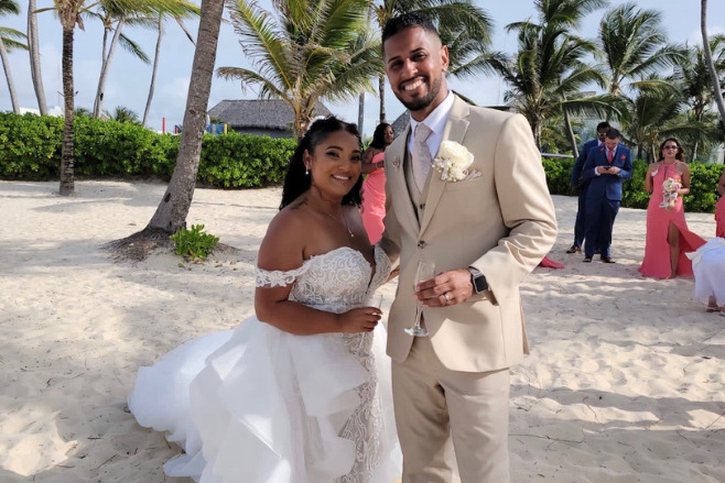 Gorgeous couple on the beach on the day of their wedding vacation