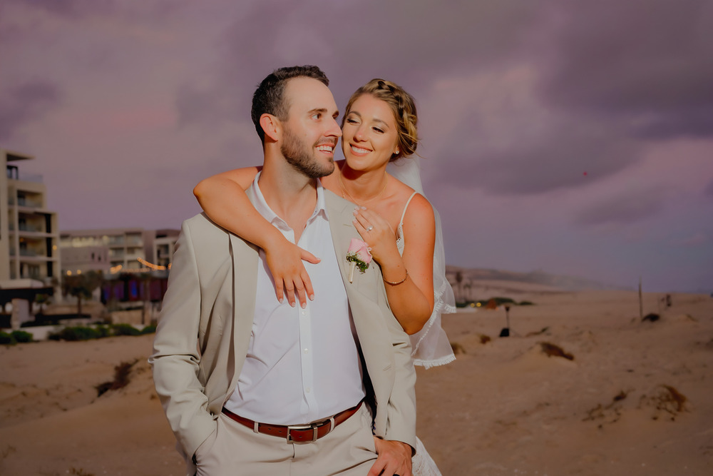 A destination wedding couple at sunset on the beach