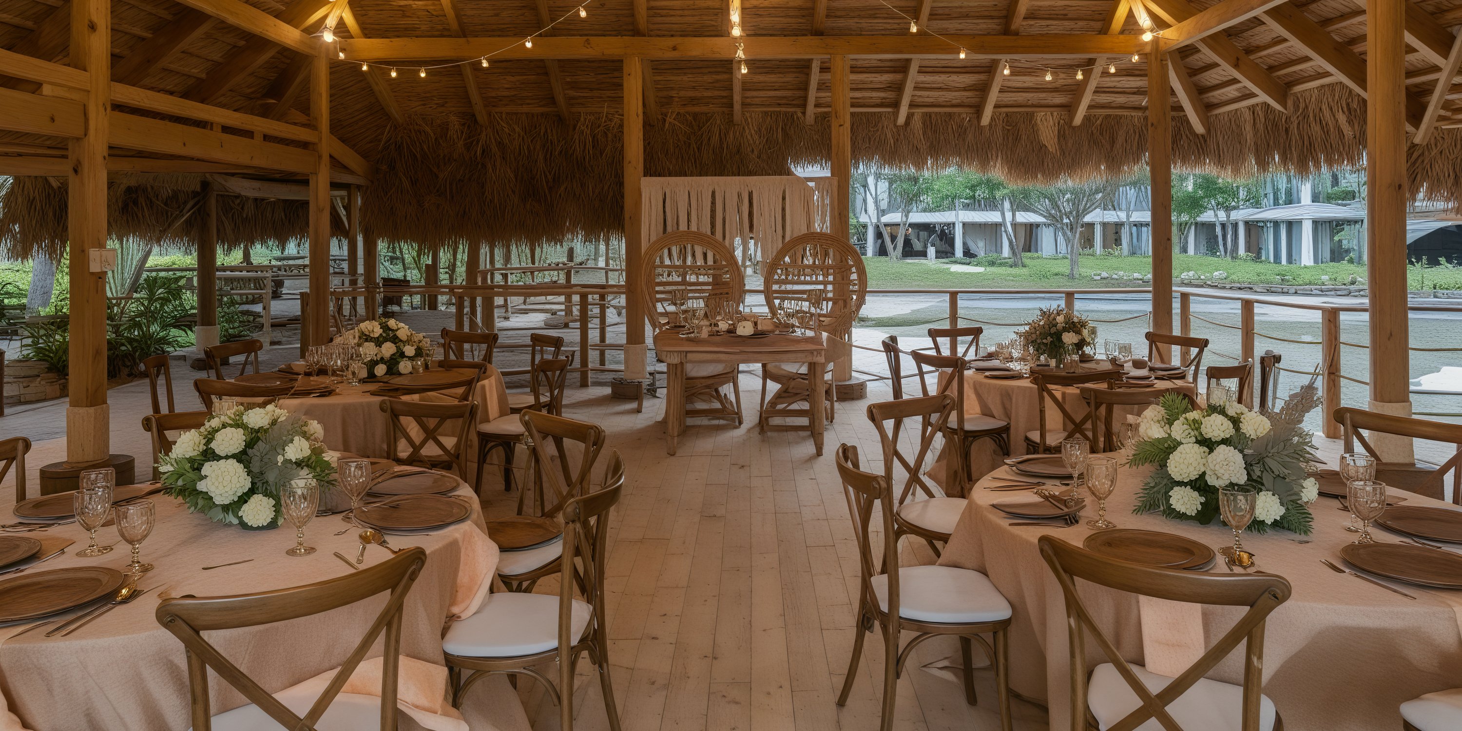 Experience a enchanting tropical outdoor dining setup perfect for a destination wedding, featuring Dreams Flora round tables adorned with exquisite floral centerpieces.