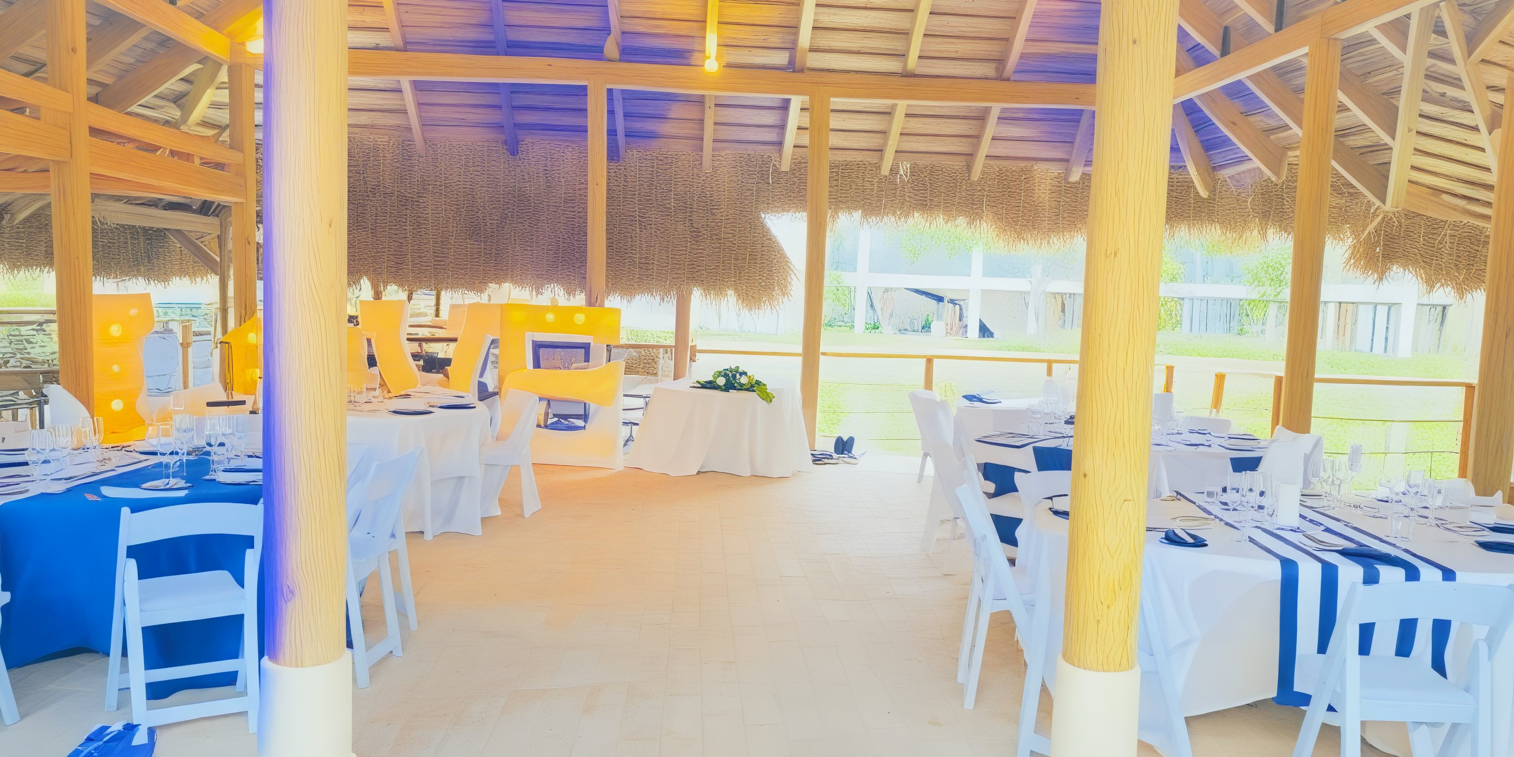 The Dreams Flora outdoor set, featuring elegant tables and chairs under a charming thatched roof, is perfect for creating an enchanting wedding pavilion or a picturesque destination wedding venue.
