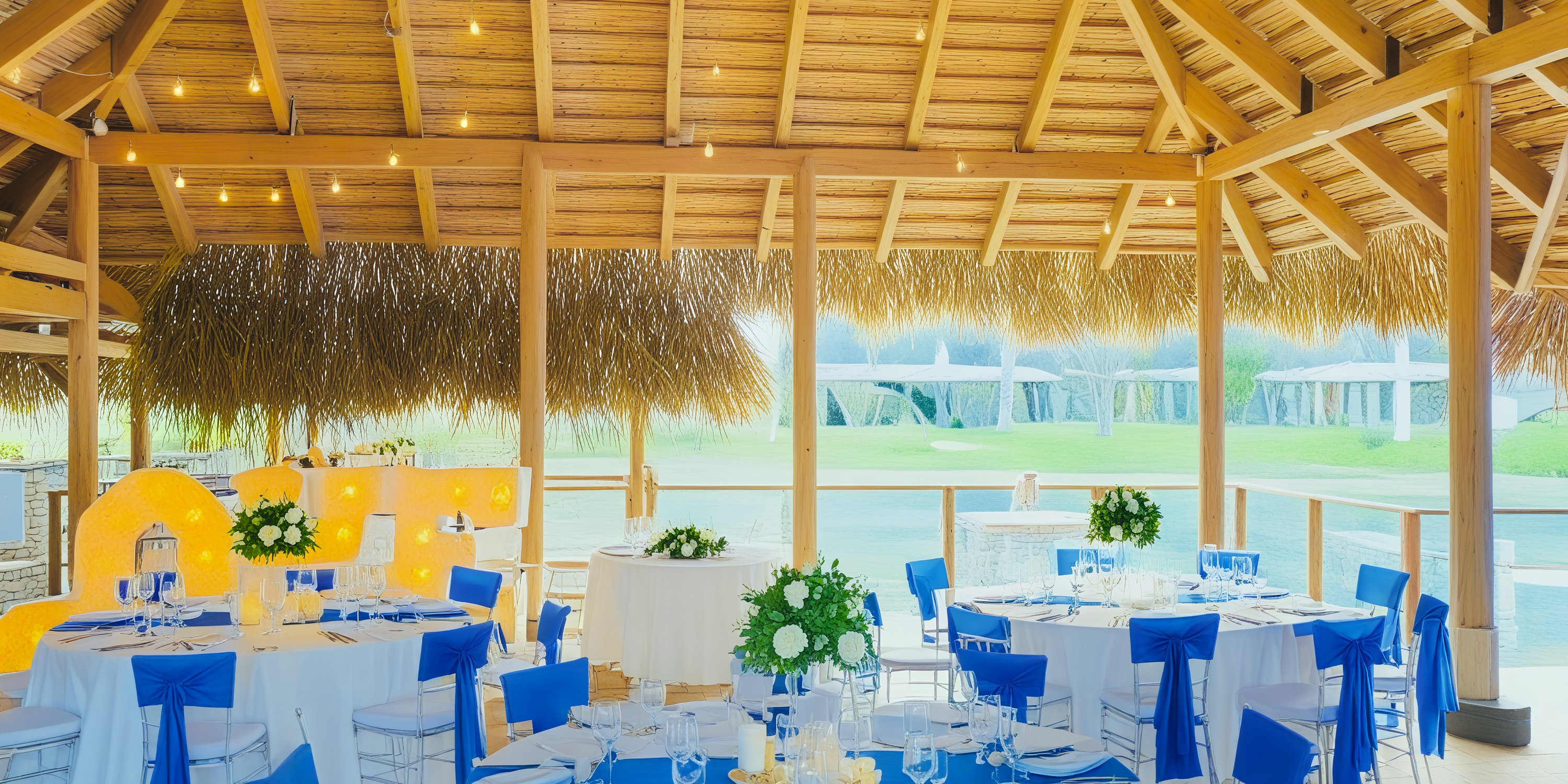 The Dreams Flora venue is elegantly adorned with blue and white decor, creating a stunning setting for an outdoor destination wedding.