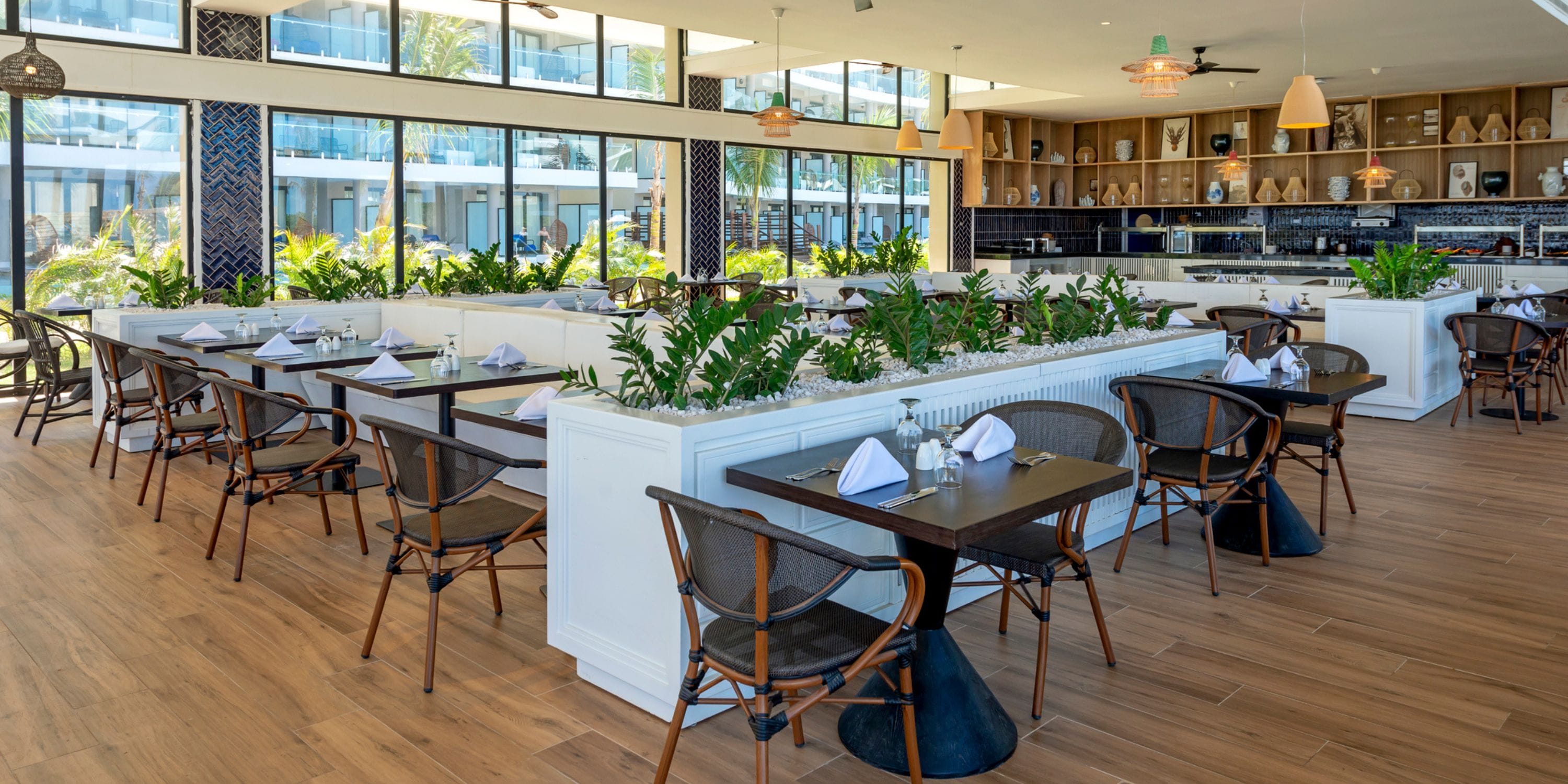 Ocean Coral Spring: Modern wedding venue with wood floors, black chairs, and large bright windows.