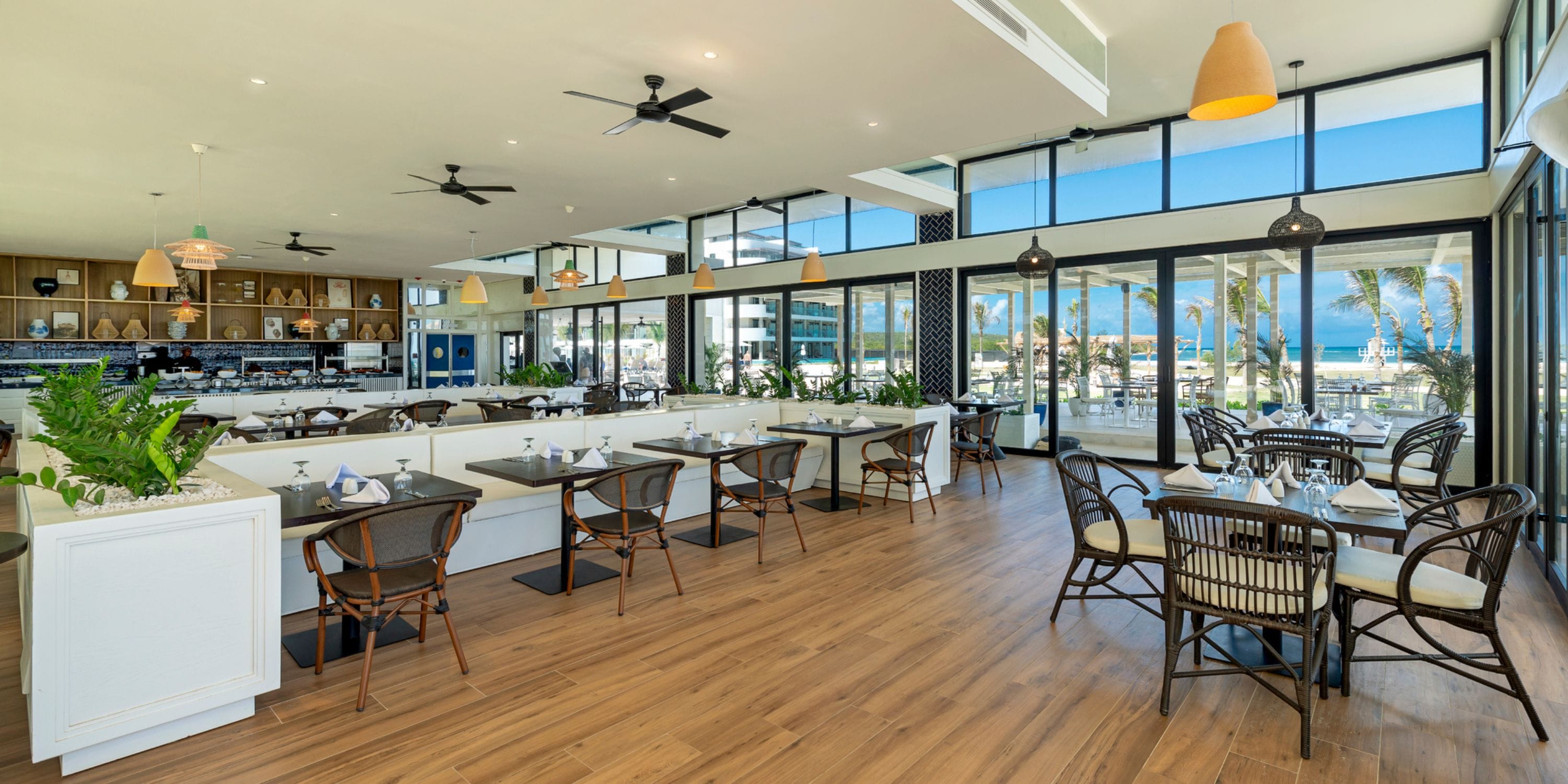 Modern Ocean Coral Spring: ideal for weddings, with wood floors, ocean views, and wicker chairs.