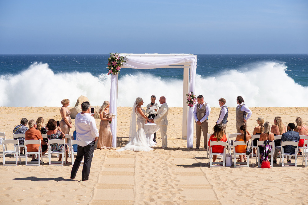 A wave crashing on the beach after a destination wedding