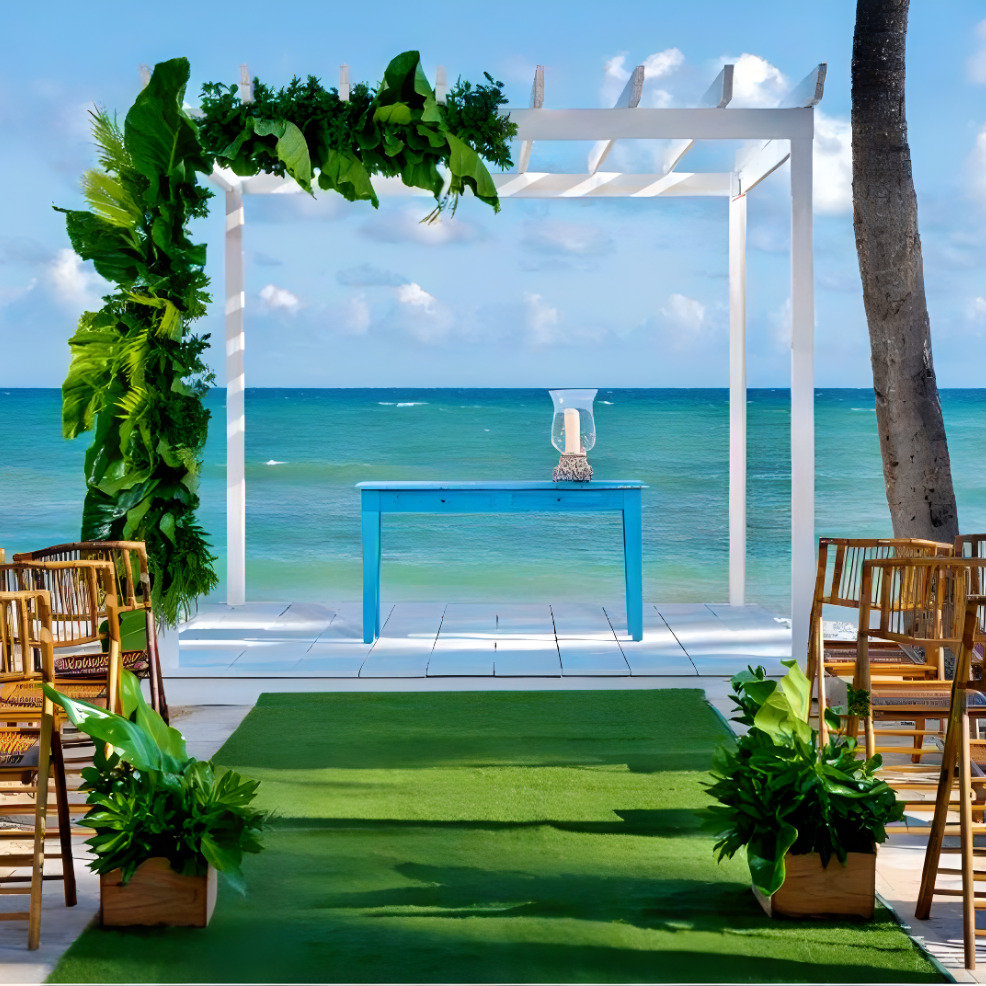 A destination wedding ceremony set up on the beach with chairs.