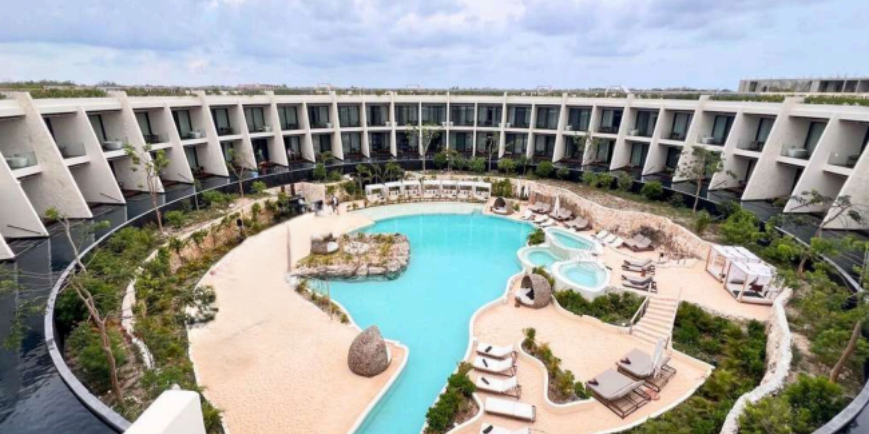 Secrets Tulum is a circular hotel with a central pool, perfect for destination weddings amid greenery.