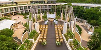 Destination wedding ceremony at Secrets Tulum with rows of chairs and floral d&eacute;cor on a wooden deck.