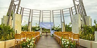 Destination wedding at Secrets Tulum featuring rows of chairs, floral d&eacute;cor, and a beautifully set altar.