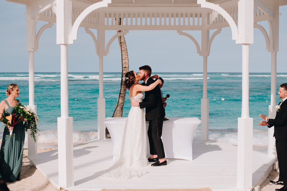 destination wedding wording couple kissing after their big day