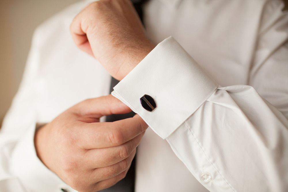 Engraved cuff links on man's wrist