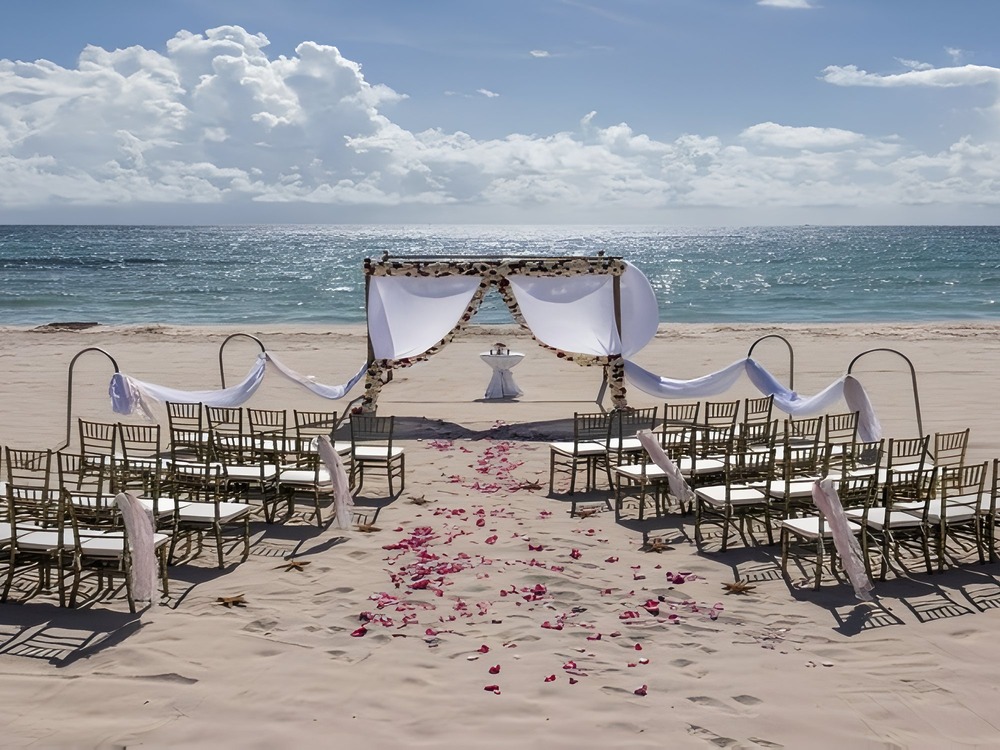 Rows of chairs and a beautiful archway set the scene for a destination wedding by the ocean—perfect inspiration for anyone wondering where to begin when planning their dream seaside wedding.