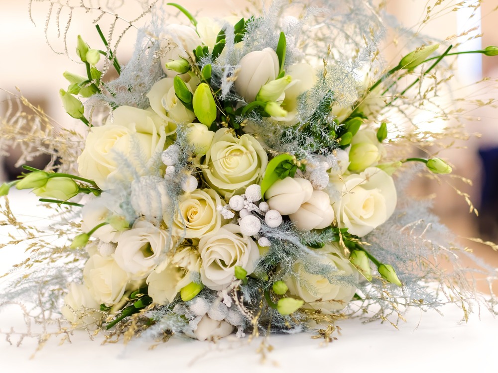 A bouquet of white roses and tulips offers the perfect inspiration for planning your dream wedding or destination wedding.