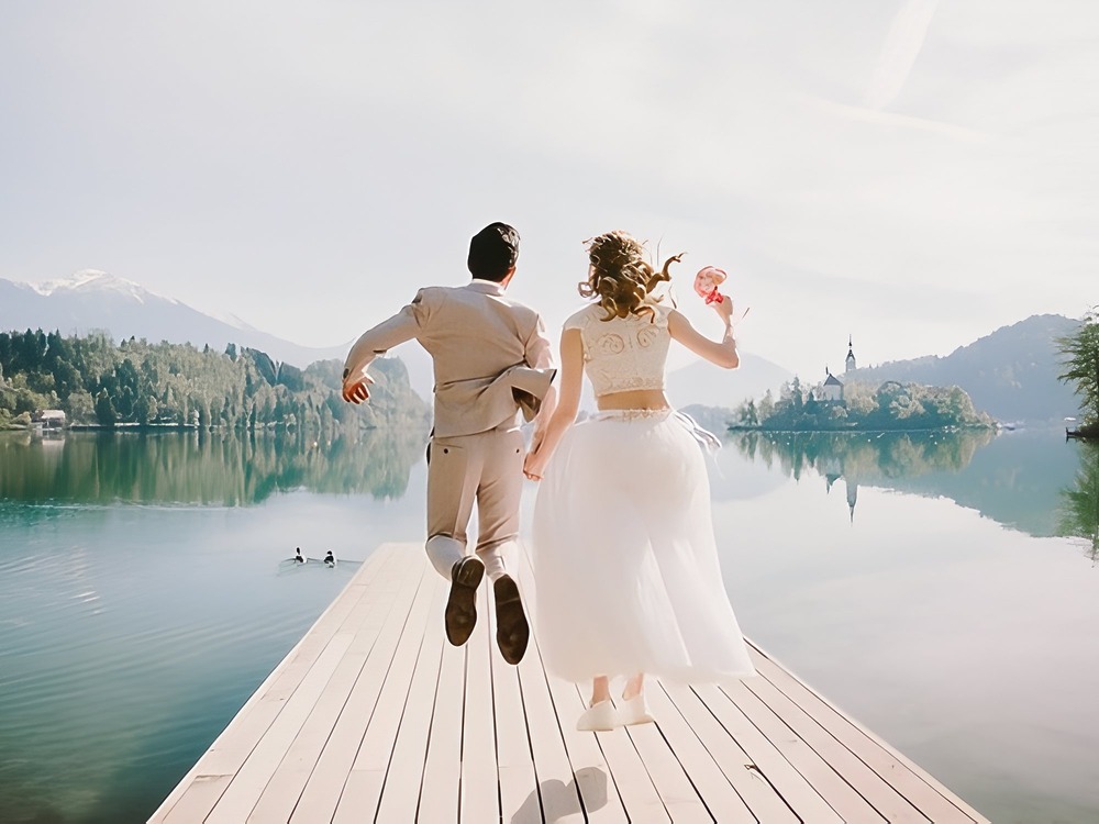 A couple joyfully leaps off a dock in celebration, embracing as they mark the start of their wedding journey. Not sure where to begin when planning your own wedding or destination wedding? This magical moment can be yours with the right inspiration and guidance.