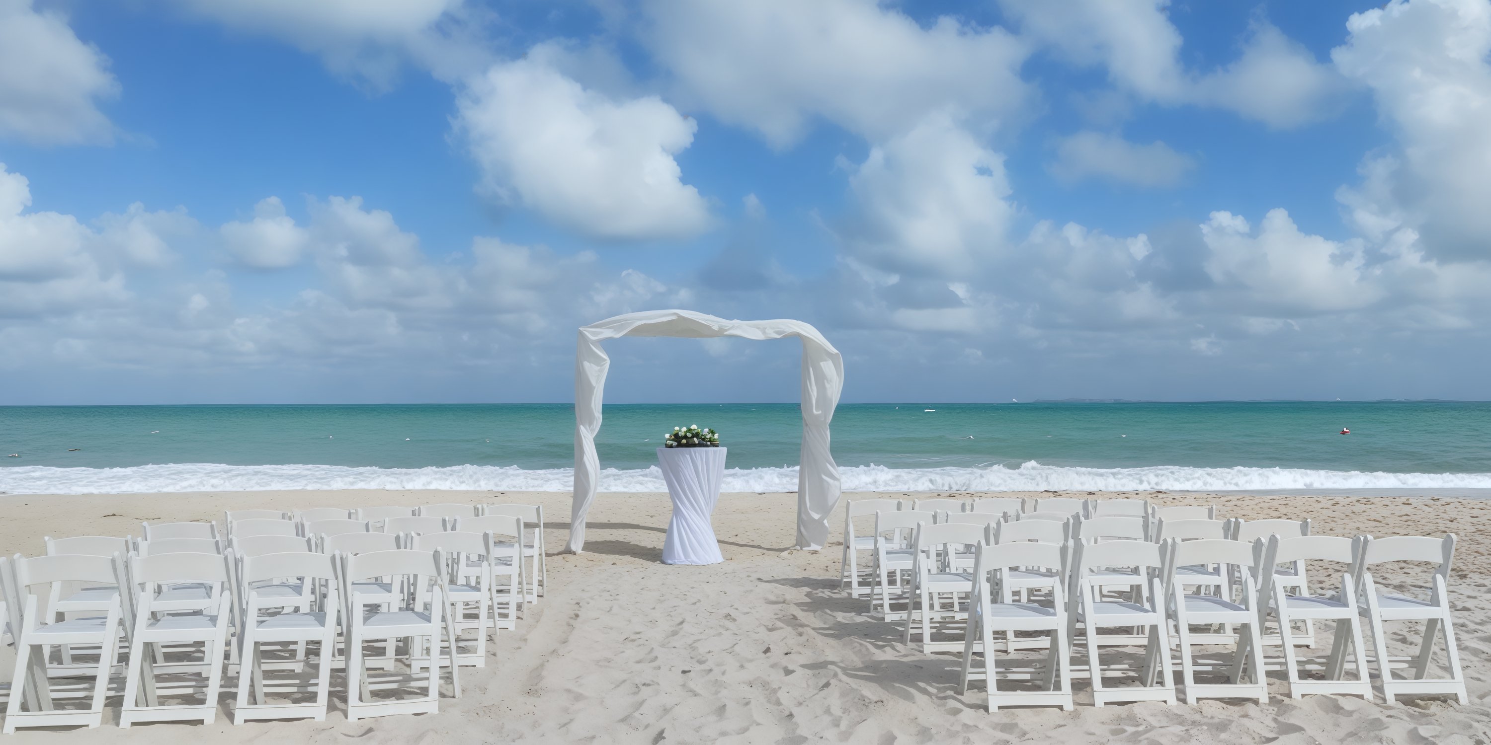 Catalonia Grand Costa Mujeres sets the perfect scene for a dream destination wedding, featuring white chairs, a beautifully adorned arch, and stunning floral arrangements on the beach.