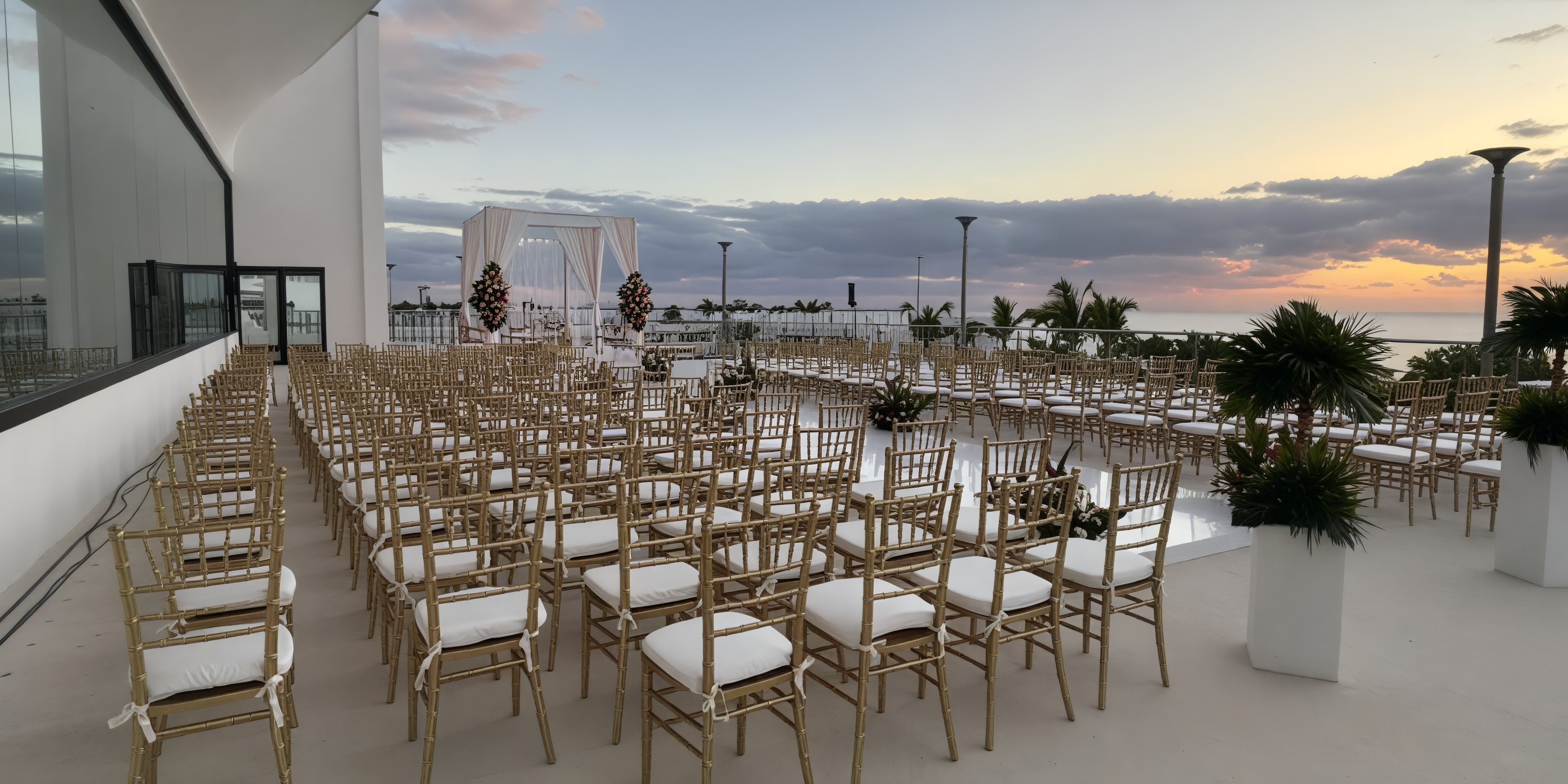 AVA Resort Cancun offers a breathtaking destination wedding experience, featuring an outdoor setup where chairs are beautifully arranged to face the altar as the sun sets.