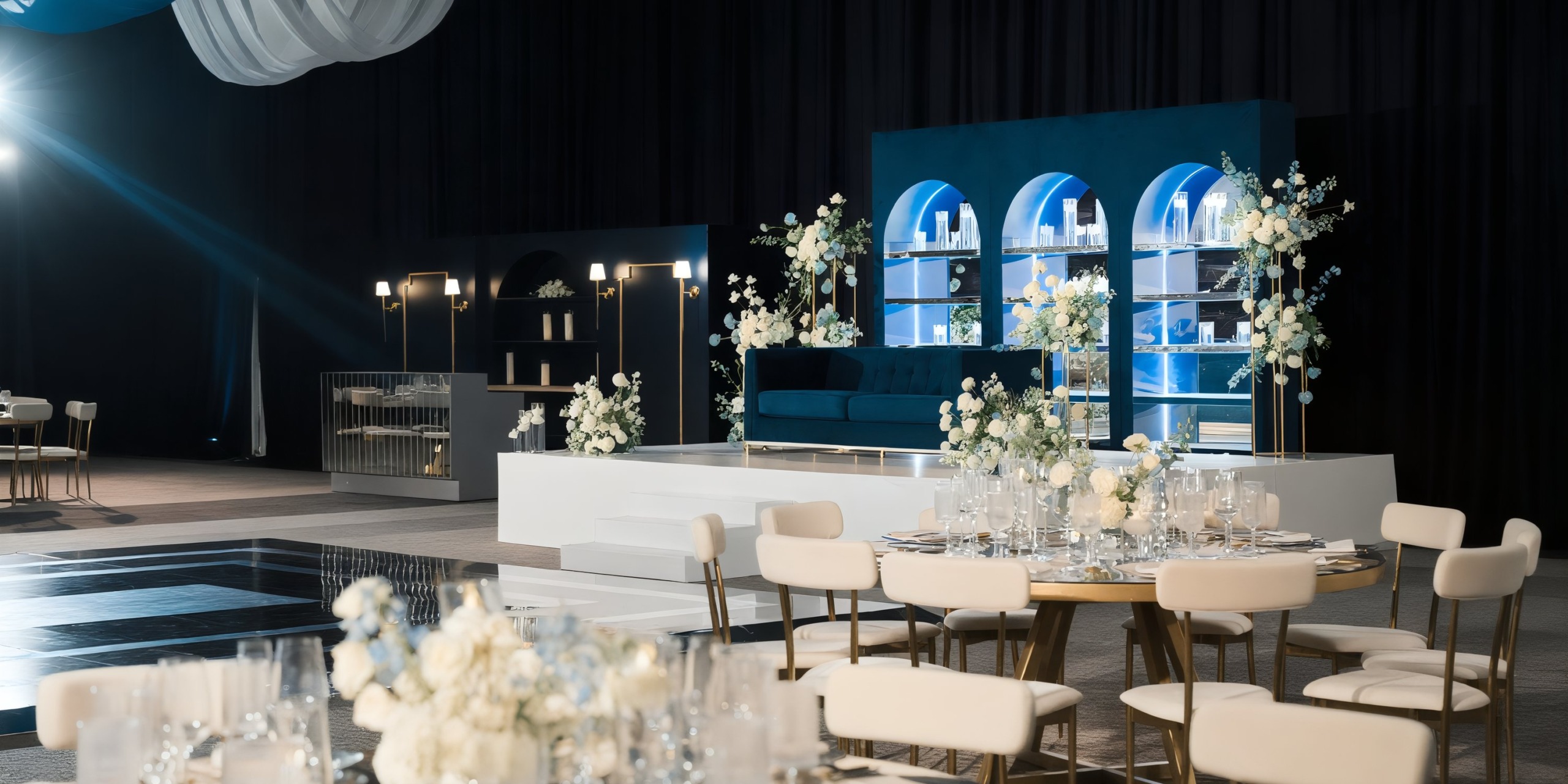 AVA Resort Cancun provides an elegant venue for a destination wedding, featuring white flowers, blue accents, and round tables.