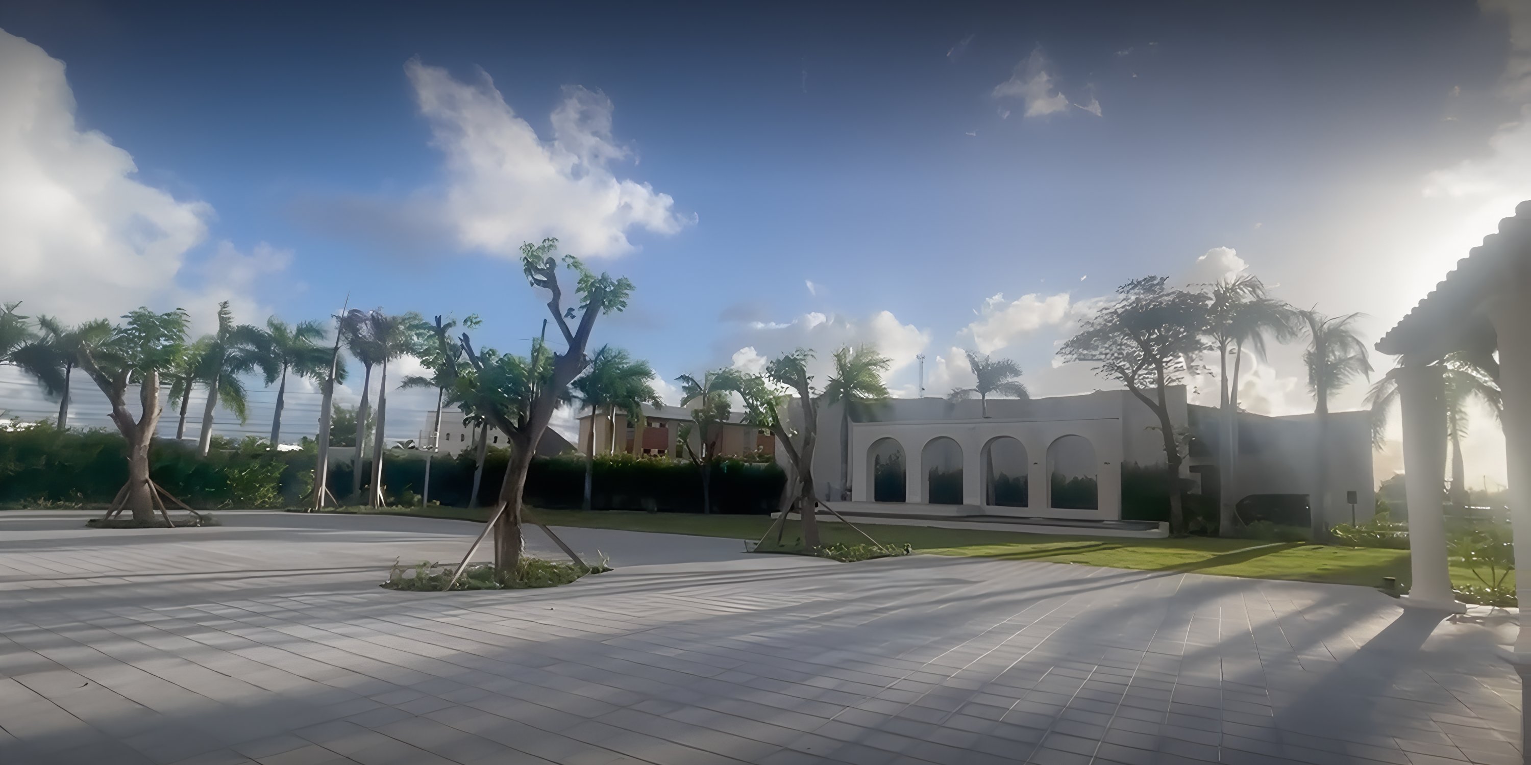 Secrets Tides offers a dreamy wedding courtyard with palms, tiled grounds, and a striking white building.