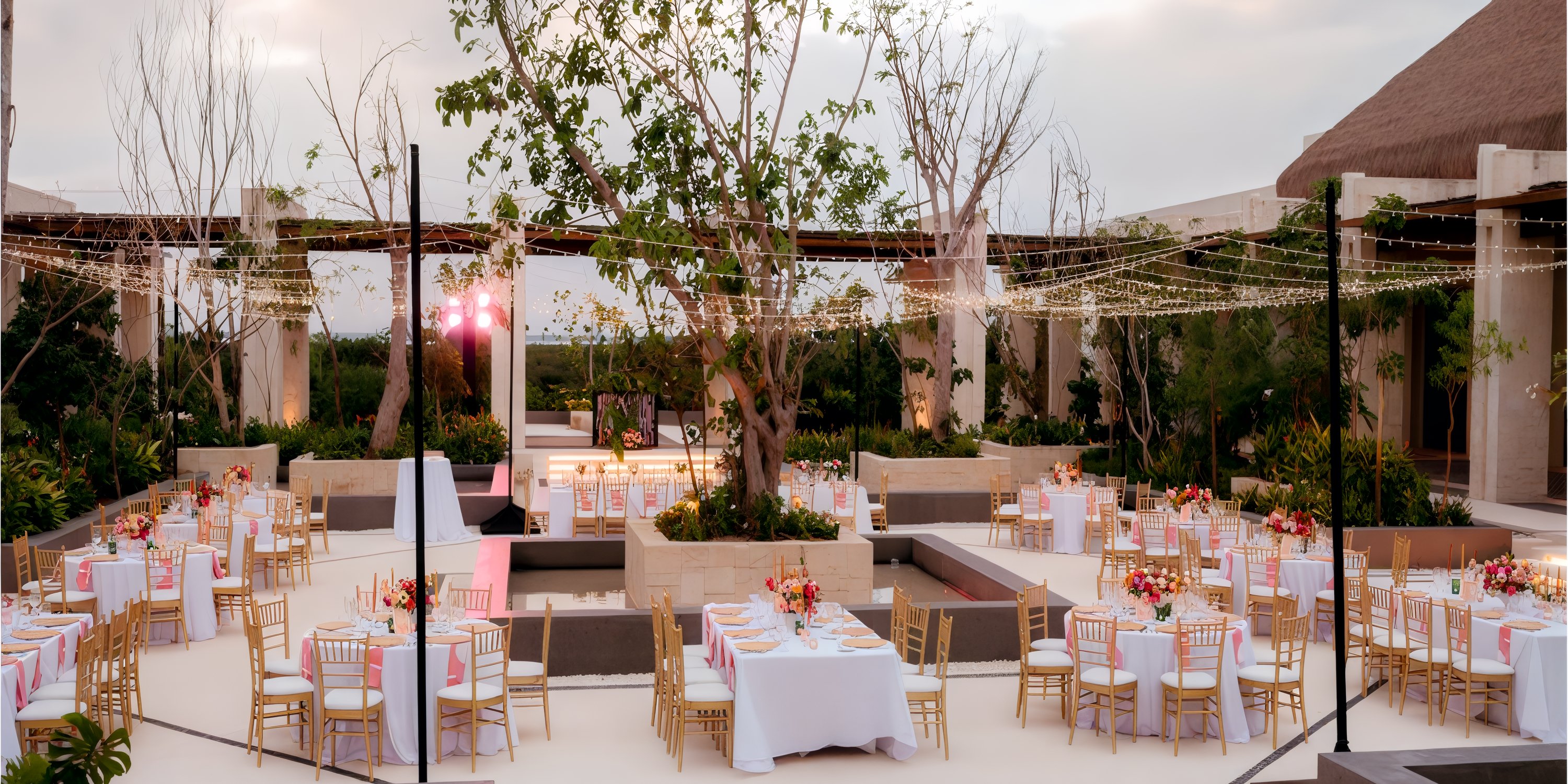 Secrets Playa Blanca Costa Mujeres destination wedding venue with round tables, florals, and string lights.