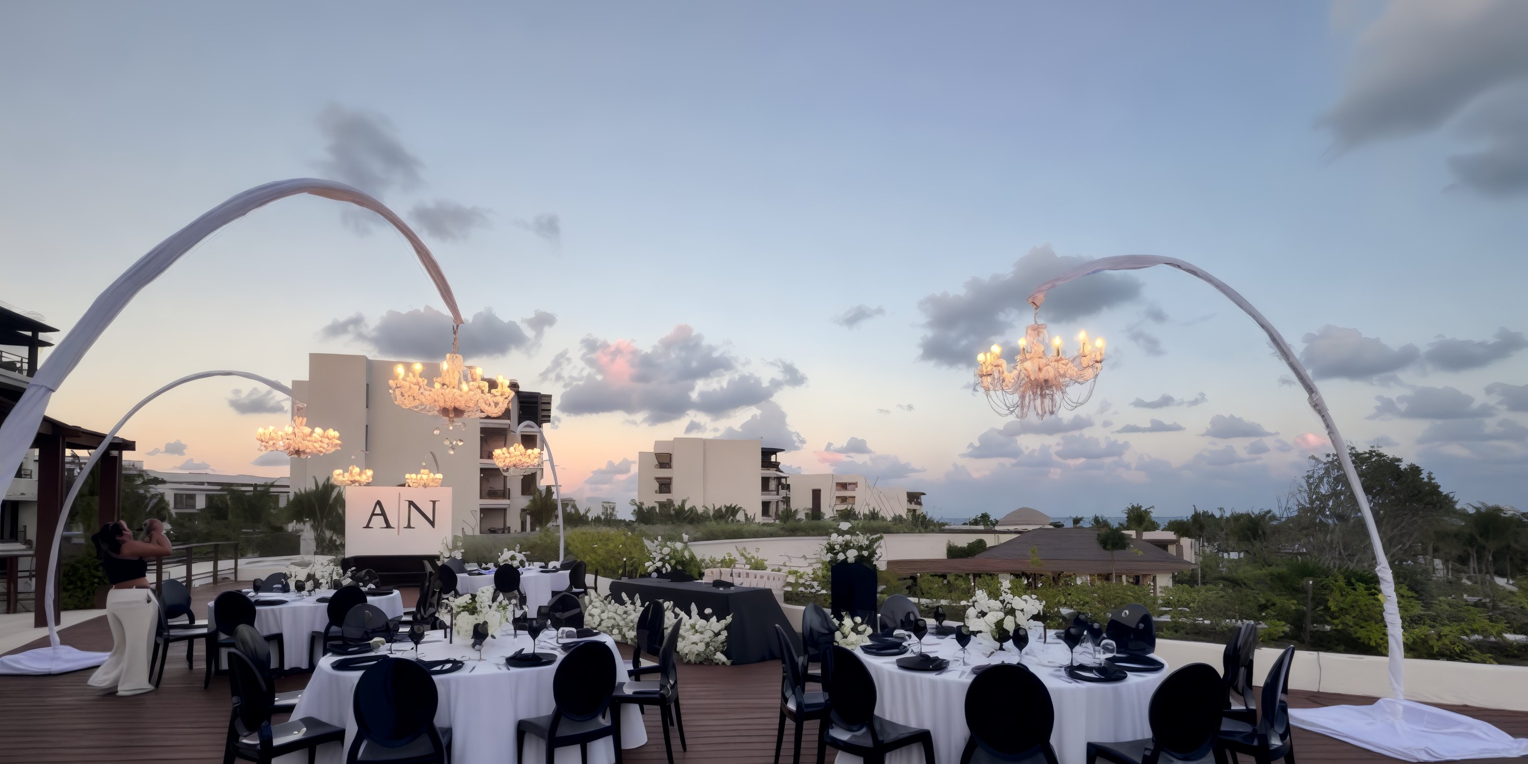Destination wedding rooftop event at Secrets Playa Blanca Costa Mujeres with elegant tables and chandeliers.