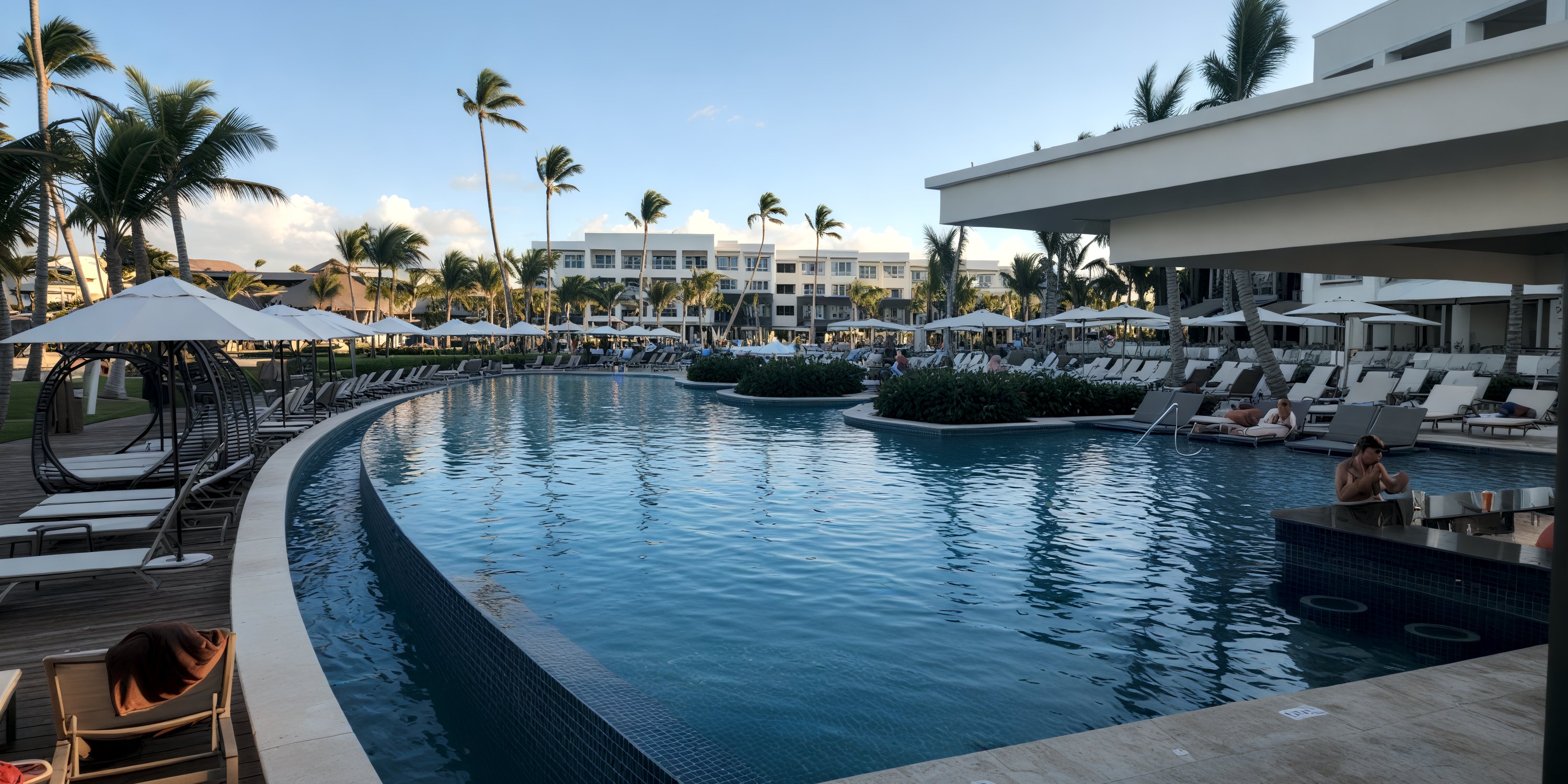 Secrets Tides offers a stunning resort pool, perfect for a destination wedding, with palm trees and lounges.